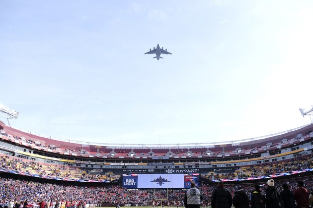 United States military aircraft flies over FedEx Field prior to an NFL football game between the New York Giants and the Washington Redskins, Sunday, Dec. 22, 2019, in Landover, Md. (AP Photo/Mark Tenally)