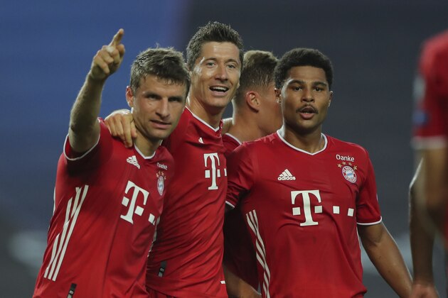 Bayern's Serge Gnabry, right, celebrates his side's second goal with teammates Robert Lewandowski, center, and Thomas Mueller during the Champions League semifinal soccer match between Lyon and Bayern Munich at the Jose Alvalade stadium in Lisbon, Portugal, Wednesday, Aug. 19, 2020. (Miguel A. Lopes/Pool via AP)