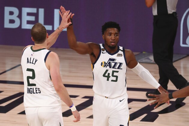 Utah Jazz guard Joe Ingles, left, and guard Donovan Mitchell, right, celebrates against the Denver Nuggets in Game 2 of an NBA basketball first-round playoff series, Wednesday, Aug. 19, 2020, in Lake Buena Vista, Fla. (Kim Klement/Pool Photo via AP)