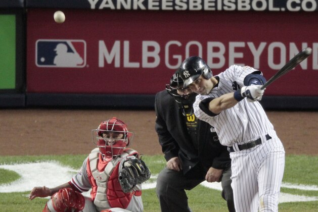 New York Yankees' Derek Jeter hits a single during the third inning of Game 6 of the Major League Baseball World Series Wednesday, Nov. 4, 2009, in New York. Philadelphia Phillies' Carlos Ruiz is catching. Umpire is Joe West.  (AP Photo/Eric Gay)