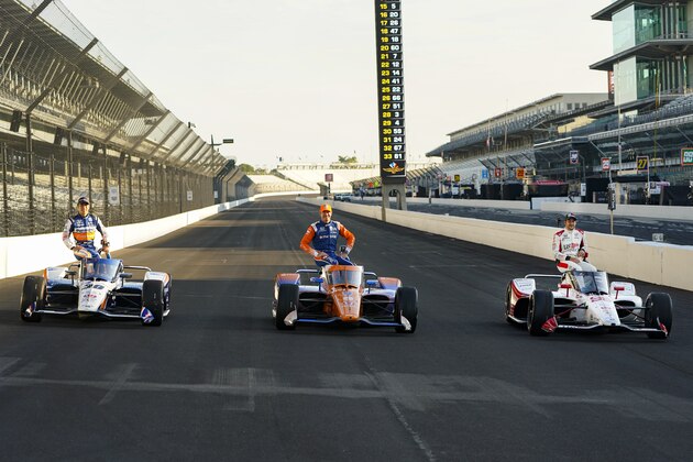 Marco Andretti, right, poses, with Scott Dixon, of New Zealand, center and Takuma Sato, of Japan, during the front row photos session for the Indianapolis 500 auto race at Indianapolis Motor Speedway in Indianapolis, Monday, Aug. 17, 2020. Andretti won the pole for Sunday's race. (AP Photo/Michael Conroy)