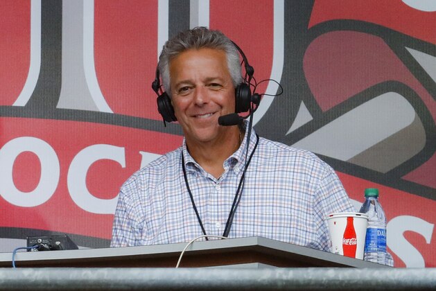 FILE - In this Sept. 25, 2019, file photo, Cincinnati Reds broadcaster Thom Brennaman sits in a special outside booth before the Reds' baseball game against the Milwaukee Brewers in Cincinnati. Brennaman used a gay slur during the broadcast of Cincinnati's game against the Kansas City Royals on Wednesday, Aug. 19, 2020. Brennaman used the slur moments after the Fox Sports Ohio broadcast returned from a commercial break before the seventh inning in the first game of a doubleheader. Brennaman did not seem to realize he was already on air. (AP Photo/John Minchillo, File)