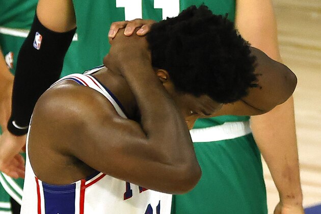 Joel Embiid of the Philadelphia 76ers grabs his head after a foul against the Boston Celtics during the first half of Game 2 of an NBA basketball first-round playoff series, Wednesday, Aug. 19, 2020, in Lake Buena Vista, Fla. (Kevin C. Cox/Pool Photo via AP)