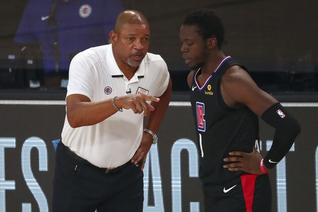 Los Angeles Clippers head coach Doc Rivers (left) talks with guard Reggie Jackson (1) during the second half of Game 2 of an NBA basketball first-round playoff series, Wednesday, Aug. 19, 2020, in Lake Buena Vista, Fla. (Kim Klement/Pool Photo via AP)