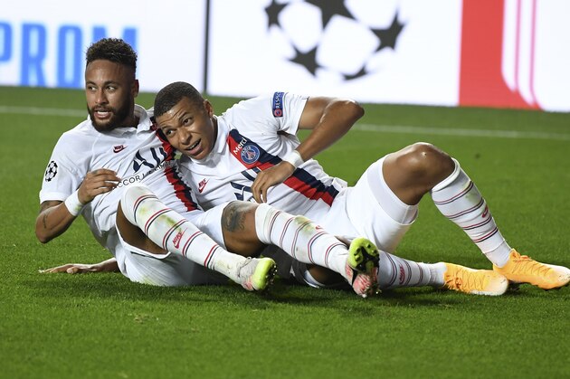 PSG's Neymar, left, celebrates with Kylian Mbappe after teammate Eric Maxim Choupo-Moting scored his team's second goal during the Champions League quarterfinal match between Atalanta and PSG at Luz stadium, Lisbon, Portugal, Wednesday, Aug. 12, 2020. (David Ramos/Pool Photo via AP)