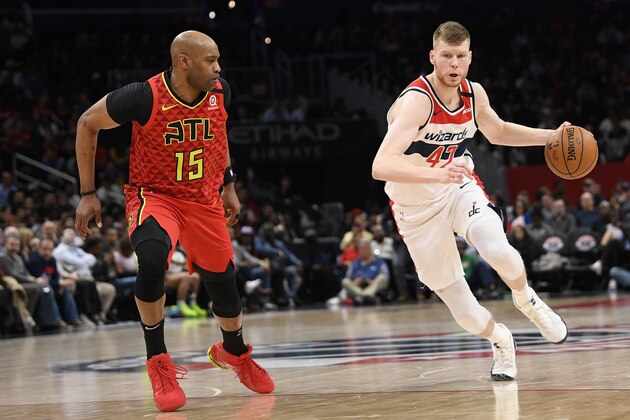 Washington Wizards forward Davis Bertans (42) dribbles the ball against Atlanta Hawks guard Vince Carter (15) during the second half of an NBA basketball game, Friday, March 6, 2020, in Washington. The Wizards won 118-112. (AP Photo/Nick Wass)