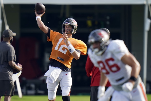 Tampa Bay Buccaneers quarterback Tom Brady (12) throws a pass to tight end Codey McElroy (86) during an NFL football training camp practice Tuesday, Aug. 18, 2020, in Tampa, Fla. (AP Photo/Chris O'Meara)