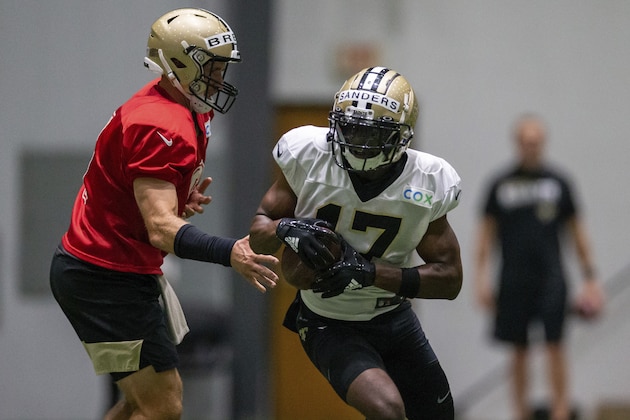New Orleans Saints quarterback Drew Brees (9), left, hands the ball to New Orleans Saints wide receiver Emmanuel Sanders (17)  during an NFL football training camp practice in Metairie, La., Wednesday, Aug. 19, 2020. ( David Grunfeld/The Advocate via AP, Pool)