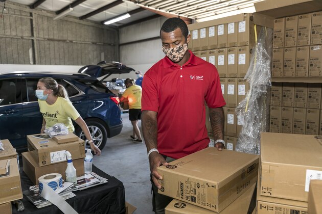 IMAGE DISTRIBUTED FOR RELIANT - Houston Texans Quarterback Deshaun Watson prepares computers at the Comp-U-Dopt distribution drive for Houston-area students as they head back to school virtually amid COVID-19 on Wednesday, August 19, 2020 in Houston. Watson teamed up with Reliant to announce a $175,000 donation to the nonprofit bringing technology access to underserved communities. (Paul Ladd/AP Images for Reliant)