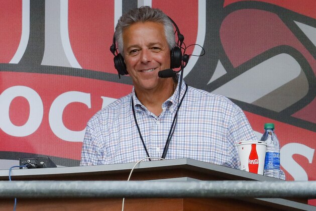 FILE - In this Sept. 25, 2019, file photo, Cincinnati Reds broadcaster Thom Brennaman sits in a special outside booth before the Reds' baseball game against the Milwaukee Brewers in Cincinnati. Brennaman used a gay slur during the broadcast of Cincinnati's game against the Kansas City Royals on Wednesday, Aug. 19, 2020. Brennaman used the slur moments after the Fox Sports Ohio broadcast returned from a commercial break before the seventh inning in the first game of a doubleheader. Brennaman did not seem to realize he was already on air. (AP Photo/John Minchillo, File)