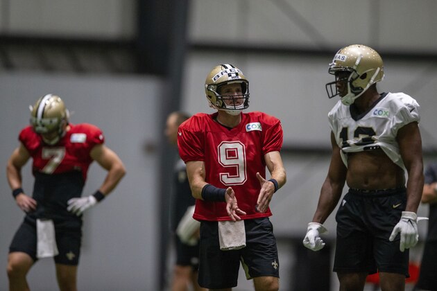 New Orleans Saints quarterback Drew Brees (9) talks with New Orleans Saints wide receiver Michael Thomas (13) during an NFL football training camp practice in Metairie, La., Wednesday, Aug. 19, 2020. (David Grunfeld/The Advocate via AP, Pool)