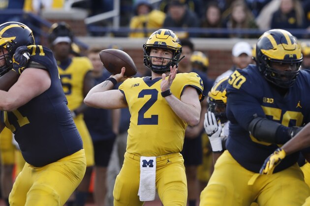 FILE- In this April 13, 2019, file photo, Michigan quarterback Shea Patterson (2) throws during the team's annual spring NCAA college football game in Ann Arbor, Mich. Patterson is back as Michigan’s starting quarterback, directing a new offense that is very familiar to him. The senior said the no-huddle, hurry-up offense scheme the seventh-ranked Wolverines will unveil in their opener Saturday against Middle Tennessee is a lot like the one he ran for two years at Ole Miss. (AP Photo/Carlos Osorio, File)