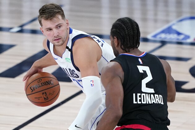 Dallas Mavericks' Luka Doncic (77) is defended by Los Angeles Clippers' Kawhi Leonard (2) during the second half of an NBA basketball game Wednesday, Aug. 19, 2020, in Lake Buena Vista, Fla. Dallas won 127-114. (AP Photo/Ashley Landis, Pool)