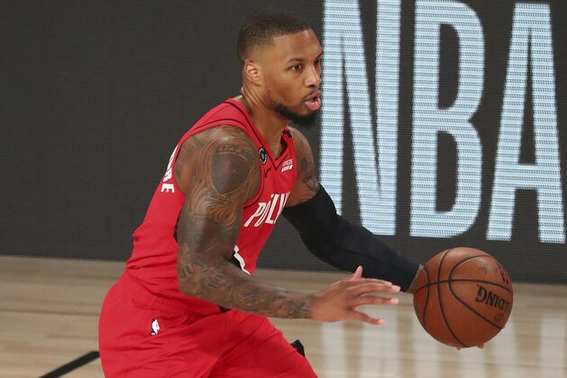 Portland Trail Blazers guard Damian Lillard (0) brings the ball upcourt against the Los Angeles Lakers during the first half of Game 2 of an NBA basketball first-round playoff series, Thursday, Aug. 20, 2020, in Lake Buena Vista, Fla. (Kim Klement/Pool Photo via AP)