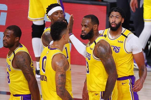 Los Angeles Lakers' LeBron James, second from right, Kyle Kuzma (0) and Anthony Davis, right, look on at the half during Game 2 of an NBA basketball first-round playoff series against the Portland Trail Blazers, Thursday, Aug. 20, 2020, in Lake Buena Vista, Fla. (Kevin C. Cox/Pool Photo via AP)