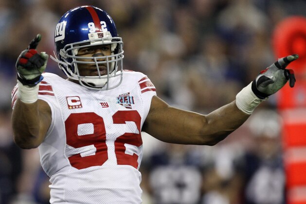 New York Giants defensive end Michael Strahan (92) celebrates after teammate Kawika Mitchell sacked New England Patriots quarterback Tom Brady during the second quarter of the Super Bowl XLII football game at University of Phoenix Stadium on Sunday, Feb. 3, 2008 in Glendale, Ariz. (AP Photo/Julie Jacobson)