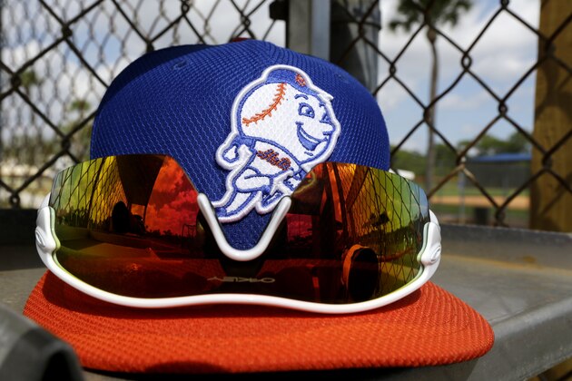 A pair of sunglasses are seen on a New York Mets hat during spring training baseball, Wednesday, Feb. 20, 2013, in Port St. Lucie, Fla. (AP Photo/Julio Cortez)