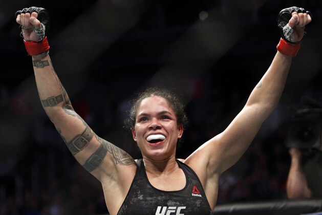 Amanda Nunes celebrates after defeating Germaine de Randamie in a mixed martial arts women's bantamweight championship bout at UFC 245, Saturday, Dec. 14, 2019, in Las Vegas. (AP Photo/John Locher)