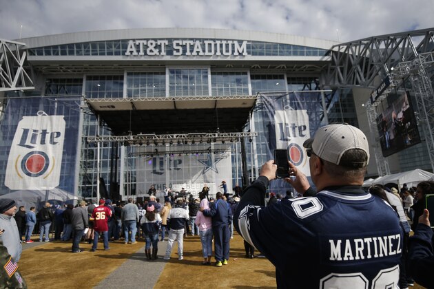Fans arrive to AT&T Stadium for for an NFL football game between the Dallas Cowboys and the Washington Redskins in Arlington, Texas, Sunday, Dec. 15, 2019. (AP Photo/Michael Ainsworth)