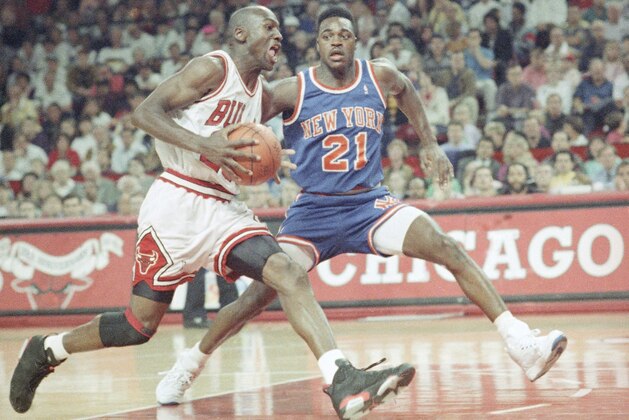 Chicago’s Michael Jordan races past New York’s Gerald Wilkins (21) as he goes to the hoop during the second half of Sunday’s NBA playoff game in Chicago on April 29, 1991. Jordan chipped in 26 points as the Bulls beat the Knicks 89-79 to go up 2-0 in the best-of-five series. (AP Photo/Fred Jewell)
