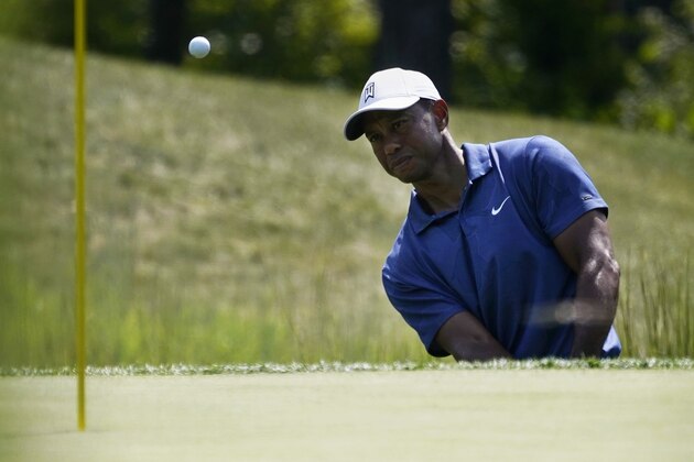 Tiger Woods makes his second attempted shot out of a trap on the fourteenth tee during the third round of the Northern Trust golf tournament at TPC Boston, Saturday, Aug. 22, 2020, in Norton, Mass. (AP Photo/Charles Krupa)