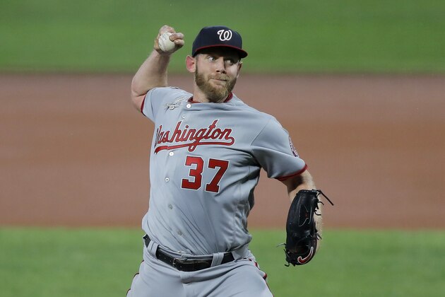 Washington Nationals starting pitcher Stephen Strasburg throws a pitch to the Baltimore Orioles during the first inning of a baseball game, Friday, Aug. 14, 2020, in Baltimore. (AP Photo/Julio Cortez)