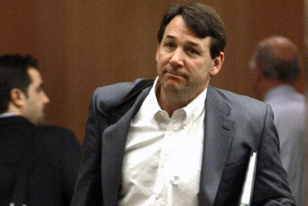 FILE - In this April 8, 2005, file photo, New York Islanders general manager Mike Milbury leaves after an NHL hockey general managers meeting at the Detroit Metropolitan Airport in Romulus, Mich. A spokesman for former Boston Bruins player and coach Milbury said on Friday, Dec. 23, 2011, that his client won't face criminal charges for a confrontation he had with a 12-year-old boy after a youth hockey game. (AP Photo/Paul Sancya, File)