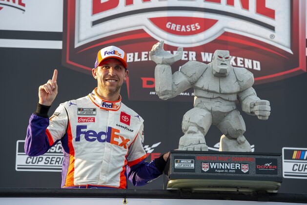 Denny Hamlin celebrates in Victory Lane after winning the NASCAR Cup Series auto race at Dover International Speedway, Saturday, Aug. 22, 2020, in Dover, Del. (AP Photo/Jason Minto)