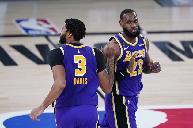 Los Angeles Lakers forward Anthony Davis (3) and forward LeBron James (23) celebrates a play during the second half of an NBA basketball first round playoff game against the Portland Trail Blazers, Saturday, Aug. 22, 2020, in Lake Buena Vista, Fla. (AP Photo/Ashley Landis, Pool)