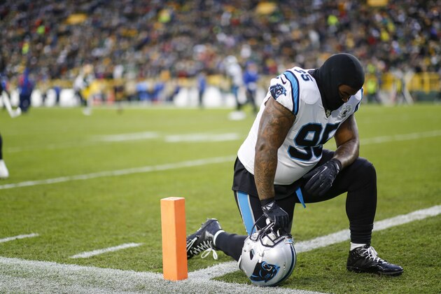 Carolina Panthers defensive tackle Dontari Poe kneels down on the field before an NFL football game between the Green Bay Packers and Carolina Panthers Monday, Nov. 11, 2019, in Green Bay, Wis. (AP Photo/Matt Ludtke)