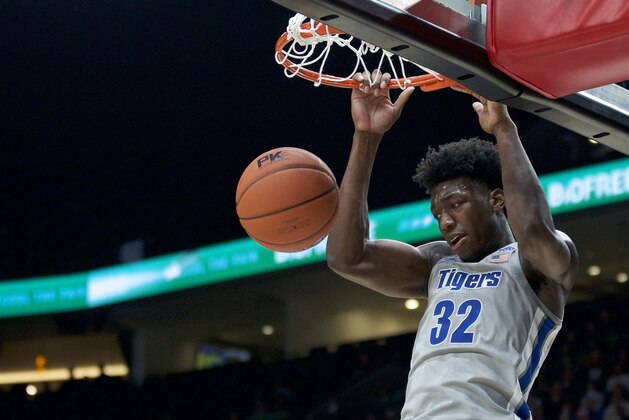 Memphis center James Wiseman dunks next to Oregon forward Shakur Juiston during the second half of an NCAA college basketball game in Portland, Ore., Tuesday, Nov. 12, 2019. Oregon won 82-74. (AP Photo/Craig Mitchelldyer)
