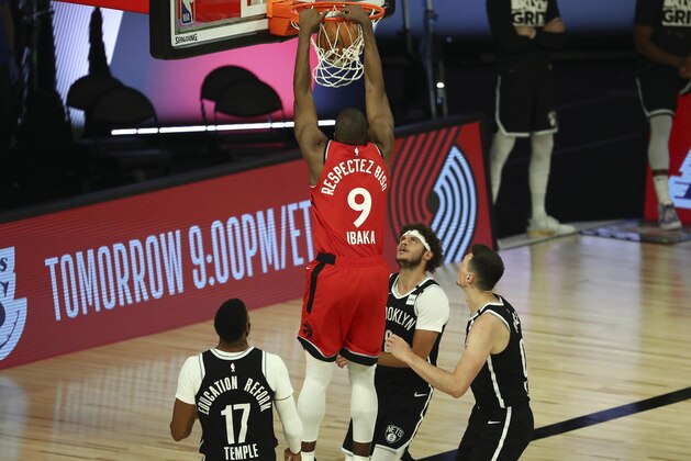 Toronto Raptors center Serge Ibaka (9) dunks to score a basket against the Brooklyn Nets during the second half of Game 4 of an NBA basketball first-round playoff series, Sunday, Aug. 23, 2020, in Lake Buena Vista, Fla. (Kim Klement/Pool Photo via AP)