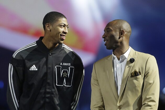 West Team's Anthony Davis, of the New Orleans Pelicans , left, speaks with Los Angeles Lakers Kobe Bryant during the NBA All Star basketball game, Sunday, Feb. 16, 2014, in New Orleans. (AP Photo/Gerald Herbert)