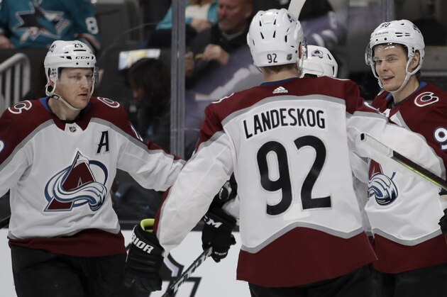 Colorado Avalanche center Vladislav Namestnikov, right, celebrates with Gabriel Landeskog (92) and Nathan MacKinnon, left, after scoring a goal against the San Jose Sharks in the second period of an NHL hockey game Sunday, March 8, 2020, in San Jose, Calif. (AP Photo/Ben Margot)