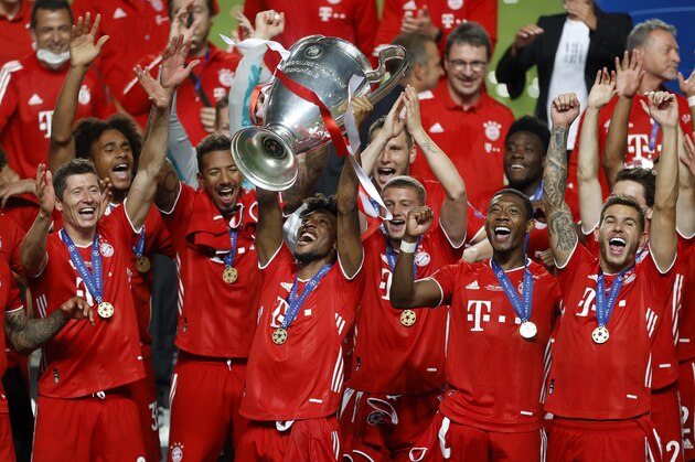 Bayern's Kingsley Coman lifts the trophy after Munich won the Champions League final soccer match between Paris Saint-Germain and Bayern Munich at the Luz stadium in Lisbon, Portugal, Sunday, Aug. 23, 2020.(Matthew Childs/Pool via AP)