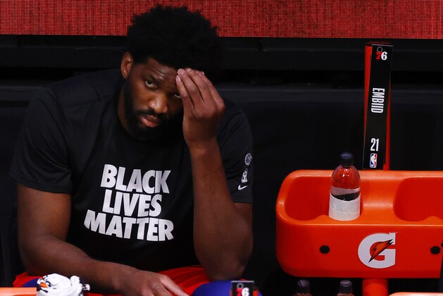 Philadelphia 76ers' Joel Embiid looks on from the bench after being injured earlier in an NBA basketball game against the Portland Trail Blazers during the third quarter of an NBA basketball game Sunday, Aug. 9, 2020, in Lake Buena Vista, Fla. (Kevin C. Cox/Pool Photo via AP)
