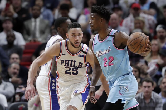 Philadelphia 76ers guard Ben Simmons (25) defends forward Jimmy Butler (22) during the first half of an NBA basketball game, Monday, Feb. 3, 2020, in Miami. (AP Photo/Lynne Sladky)