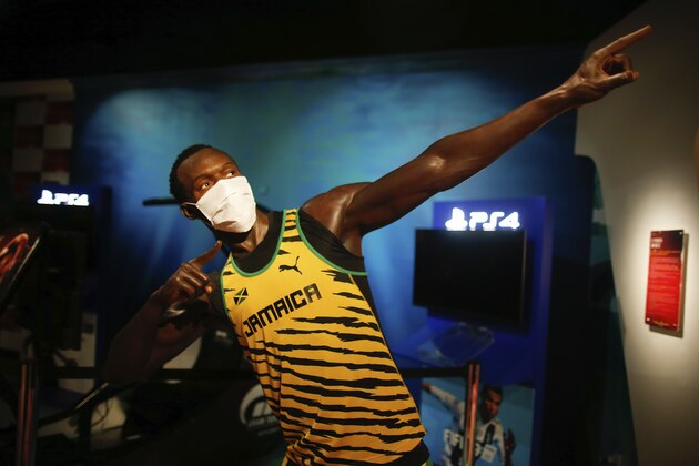 In order to raise awareness against the spread of the coronavirus, a mask is placed on the wax figure of Jamaica's Usain Bolt at Madame Tussauds attraction in Istanbul, Saturday, July 11, 2020. Turkish authorities have made the wearing of masks mandatory in most of the country to curb the spread of COVID-19 following an uptick in confirmed cases since the reopening of many businesses. (AP Photo/Emrah Gurel)