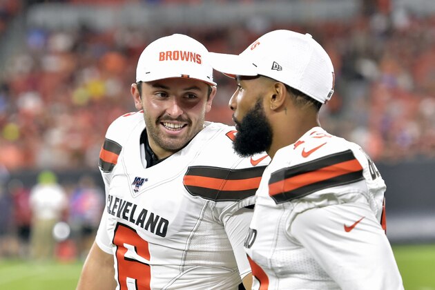 FILE - In this Aug. 8, 2019, file photo, Cleveland Browns' Baker Mayfield, left, smiles as he talks with wide receiver Odell Beckham Jr. during the second half of an NFL preseason football game against the Washington Redskins in Cleveland. Beckham believes the Browns offense will come around. Until then, he’s going to defend Mayfield. (AP Photo/David Richard, File)