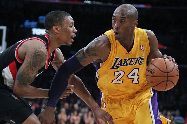 Los Angeles Lakers guard Kobe Bryant (24) drives against Portland Trail Blazers guard Damian Lillard, left, during the second quarter of an NBA basketball game, Friday, Dec. 28, 2012, in Los Angeles. (AP Photo/Alex Gallardo)