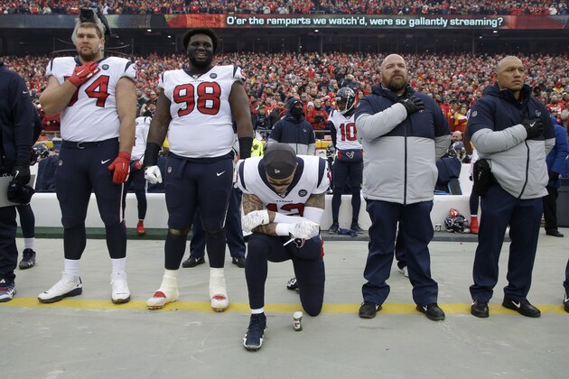 Houston Texans wide receiver Kenny Stills (12) kneels during the playing of the National Anthem before an NFL divisional playoff football game against the Kansas City Chiefs, in Kansas City, Mo., Sunday, Jan. 12, 2020. (AP Photo/Charlie Riedel)