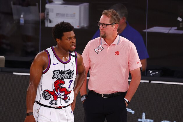 Toronto Raptors head coach Nick Nurse, right, talks with Kyle Lowry (7) during the first quarter of an NBA basketball game against the Memphis Grizzlies, Sunday, Aug. 9, 2020, in Lake Buena Vista, Fla. (Kevin C. Cox/Pool Photo via AP)