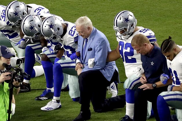 The Dallas Cowboys, led by owner Jerry Jones, center, take a knee prior to the national anthem prior to an NFL football game against the Arizona Cardinals, Monday, Sept. 25, 2017, in Glendale, Ariz. (AP Photo/Matt York)