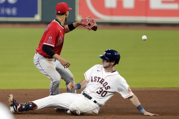 Houston Astros' Kyle Tucker (30) is safe on the slide into second base as he beats the throw to Los Angeles Angels shortstop Andrelton Simmons, left, during the sixth inning of a baseball game Monday, Aug. 24, 2020, in Houston. (AP Photo/Michael Wyke)