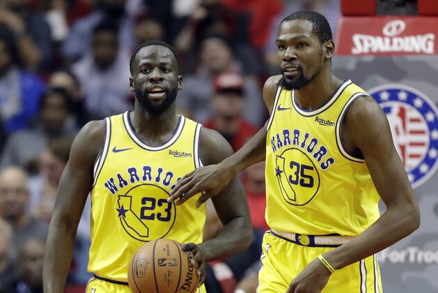 Golden State Warriors' Kevin Durant (35) pats Draymond Green (23) on the chest after a turnover during the second half of an NBA basketball game against the Houston Rockets Thursday, Nov. 15, 2018, in Houston. (AP Photo/David J. Phillip)