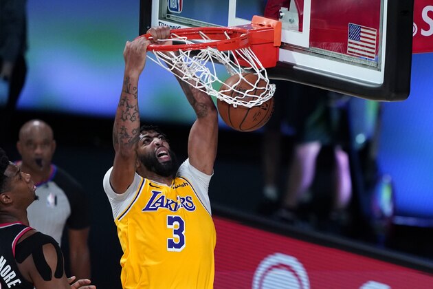Los Angeles Lakers forward Anthony Davis (3) slam dunks over Portland Trail Blazers center Hassan Whiteside during the second half of an NBA basketball game Tuesday, Aug. 18, 2020, in Lake Buena Vista, Fla. (AP Photo/Ashley Landis, Pool)