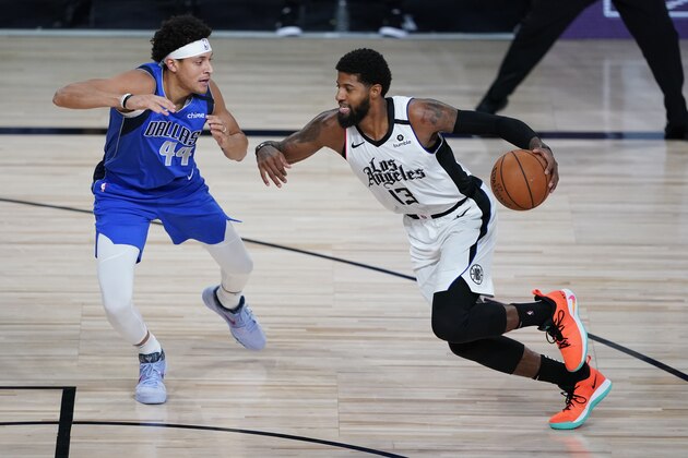 Los Angeles Clippers' Paul George (13) drives to the basket against Dallas Mavericks' Justin Jackson (44) during the second half of an NBA basketball first round playoff game Tuesday, Aug. 25, 2020, in Lake Buena Vista, Fla. (AP Photo/Ashley Landis, Pool)