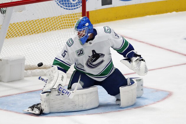 Vancouver Canucks goaltender Jacob Markstrom (25) looks back to see the puck reach the back of the net on a shot by Dallas Stars right wing Corey Perry (10) in the third period of an NHL hockey game in Dallas, Tuesday, Nov. 19, 2019. The Stars won 6-1. (AP Photo/Tony Gutierrez)