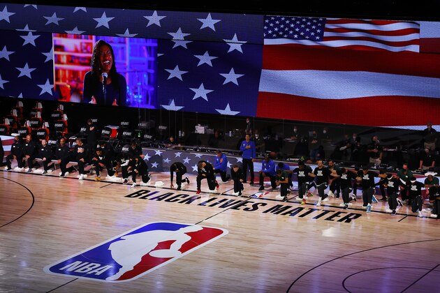 Denver Nuggets and Utah Jazz team members kneel during the national anthem before Game 5 of an NBA basketball first-round playoff series, Tuesday, Aug. 25, 2020, in Lake Buena Vista, Fla. (Mike Ehrmann/Pool Photo via AP)