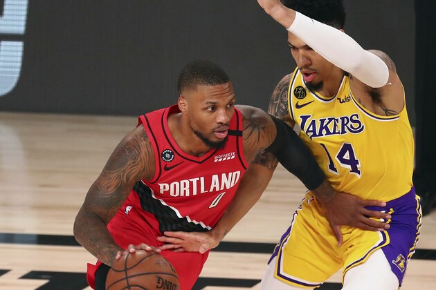 Portland Trail Blazers guard Damian Lillard (0) drives against Los Angeles Lakers guard Danny Green (14) during the first half of Game 2 of an NBA basketball first-round playoff series, Thursday, Aug. 20, 2020, in Lake Buena Vista, Fla. (Kim Klement/Pool Photo via AP)